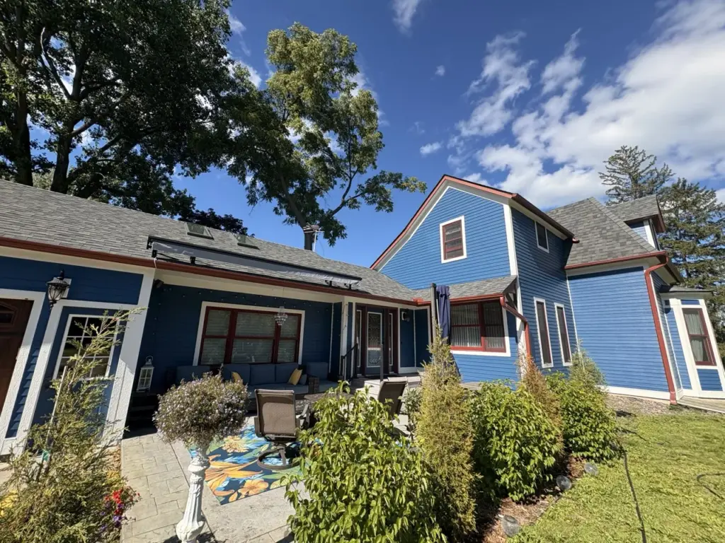 Exterior house painting by Smooth Painting — blue two story
