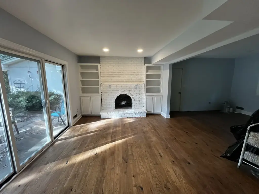 Freshly painted living room with white brick fireplace